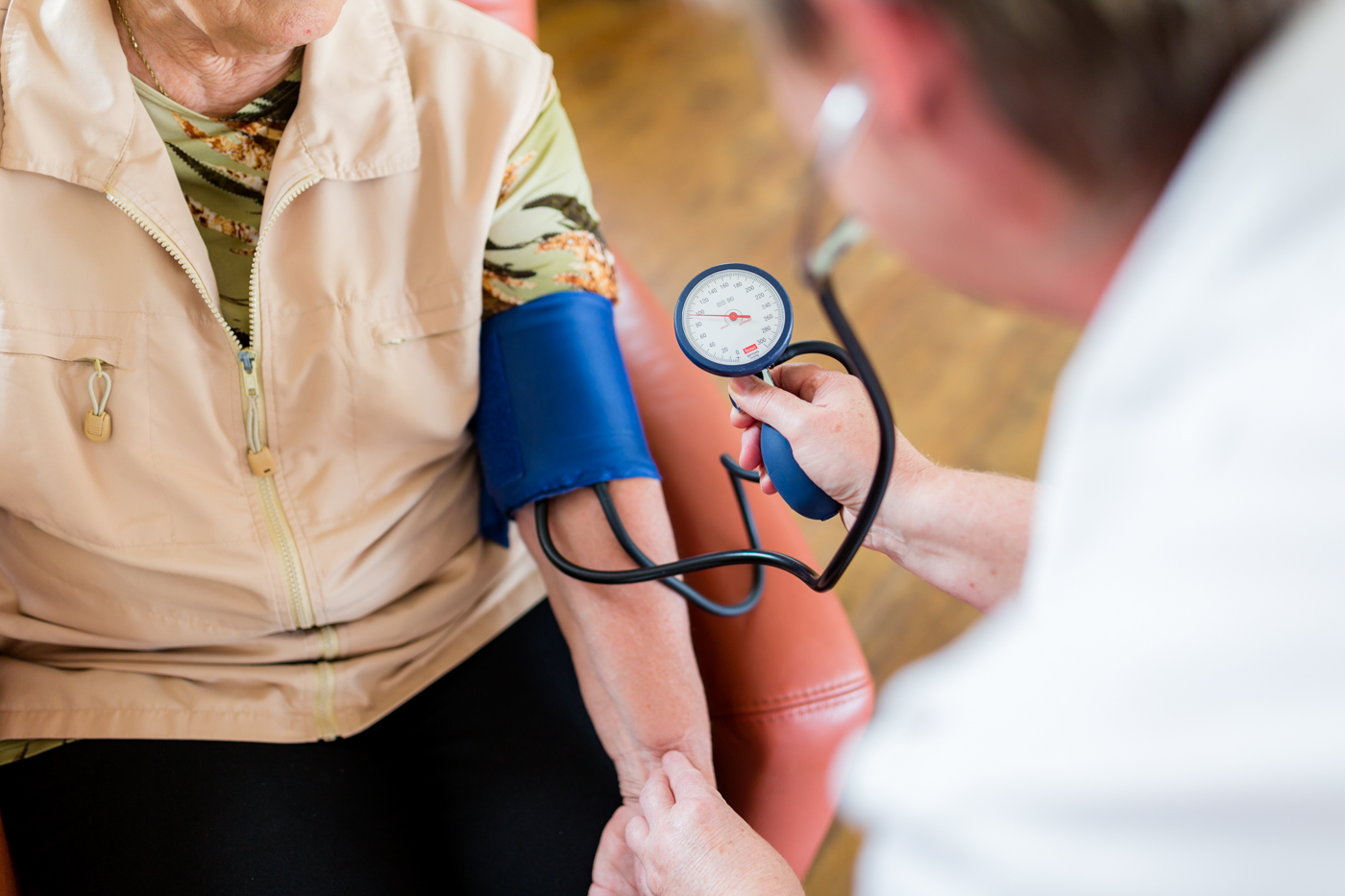 Pflegekraft misst bei einer Patientin den Blutdruck